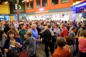 Visitors crowd the concession lobby of the new Carmike Cinemas 12 during the VIP night
