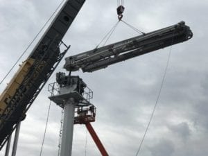 placing pump on mast with crane